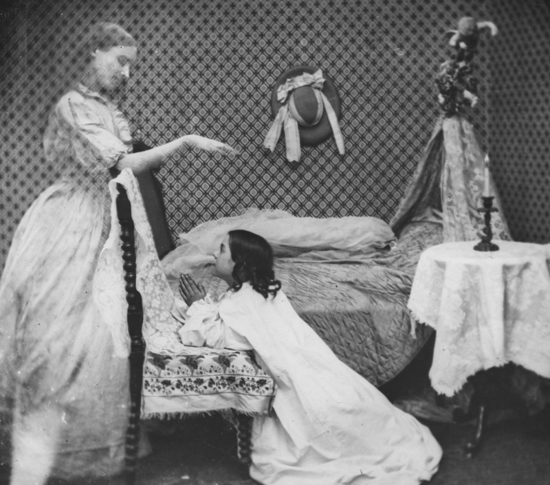 The ghost of a woman appears to a girl at prayer by her bedside, circa 1865. London Stereoscopic Company Comic Series - 183 (Photo by London Stereoscopic Company/Getty Images)